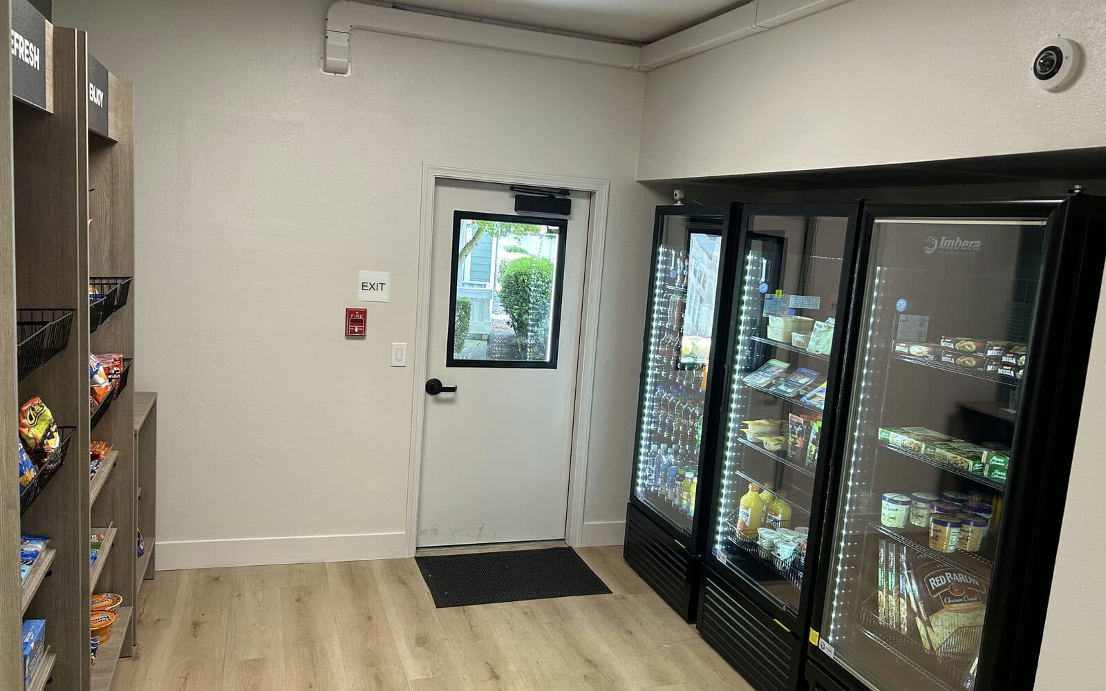 Micro market with fresh-food coolers and snack shelving in a breakroom