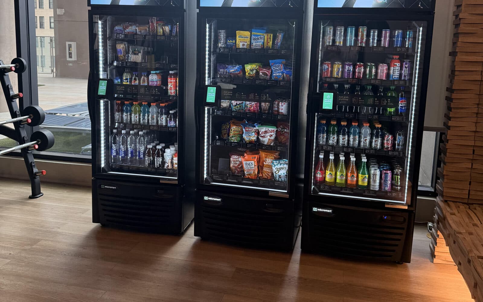 Three smart coolers beside the windows of a fitness room